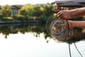 Man holding caught fish at lake. Space for text Royalty Free Stock Photo