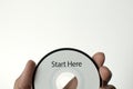 A man is holding a cd with a start here message Royalty Free Stock Photo