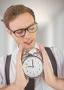 man holding clock in front of blurred bright background Royalty Free Stock Photo