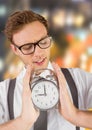 man holding clock in front of blurred colorful background Royalty Free Stock Photo
