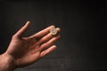 Man holding a coins. Euro currency on a black background. HandÃÂ´s of young man holding a money. Finance and banking concept.