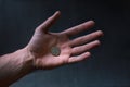 Man holding a coins. Euro currency on a black background. HandÃÂ´s of young man holding a money. Finance and banking concept.