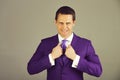 Man holding collar in elegant violet formal suit jacket