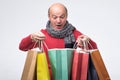 Man holding colored shopping bag and looking with surprise inside. Royalty Free Stock Photo