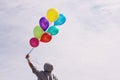 Man holding colorful balloons