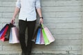 Man holding colorful shopping bag outdoors. shopaholic male stan