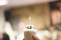 Man holding cols tasty frappe with blurred background