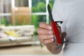 Man holding compact portable multitool indoors, closeup. Space for text Royalty Free Stock Photo