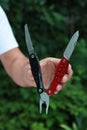 Man holding compact portable multitool outdoors, closeup Royalty Free Stock Photo