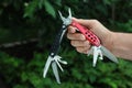 Man holding compact portable multitool outdoors, closeup Royalty Free Stock Photo