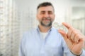 man holding contact eye lenses and container in hand, applying eye contacts from lens box Royalty Free Stock Photo