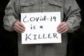 Man holding covid-19 is a killer sign