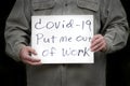 Man holding covid-19 put me out of work homemade sign Royalty Free Stock Photo