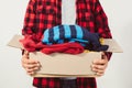 Man holding a crate of second-hand clothes unused clothes Royalty Free Stock Photo