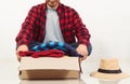 Man holding a crate of second-hand clothes unused clothes Royalty Free Stock Photo