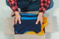 Man holding a crate of second-hand clothes unused clothes Royalty Free Stock Photo