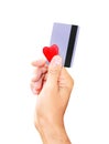 Man holding a credit card and a small heart isolated white