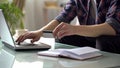 Man holding credit card, typing on laptop, paying for utilities, shopping online Royalty Free Stock Photo