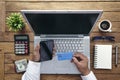 Man holding credit card and using laptop computer. Online Shopping Concept Royalty Free Stock Photo