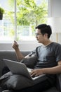 Man holding credit card and using laptop computer for shopping online at home. Royalty Free Stock Photo