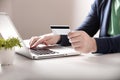 Man holding credit card and using laptop. Online shopping concept Royalty Free Stock Photo