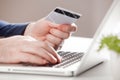 Man holding credit card and using laptop. Online shopping concept Royalty Free Stock Photo