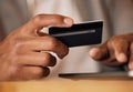 .. Man holding credit card and using tablet. Closeup of mans hands holding bank card while doing online shopping or