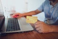 Man holding credit card while working with laptop Royalty Free Stock Photo