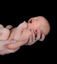 Man holding crying infant. isolated on black