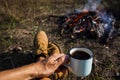 man holding cup coffee campfire. High quality photo Royalty Free Stock Photo