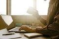 A man holding a cup of coffee and working on laptop in offic