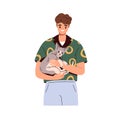 Man holding cute cat in hands. Happy pet owner with adorable funny kitty in arms. Person caring about lovely sweet