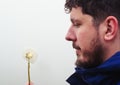 man holding dandelion with water drops in the hands and making a wish Royalty Free Stock Photo