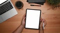 Man holding digital tablet with blank display and stylus pen on wooden table. Royalty Free Stock Photo