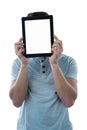 Man holding a digital tablet in front of his face Royalty Free Stock Photo