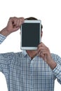 Man holding digital tablet in front of his face Royalty Free Stock Photo