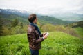 Man holding digital tablet on the mountain top Royalty Free Stock Photo