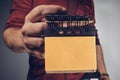 Man holding dirty sticky notes in the hand