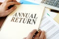 Man holding document with Annual return.