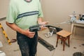 Man is holding drill mixer in his hands. Maintenance repair works renovation in the flat. Restoration indoors. Man is working with Royalty Free Stock Photo