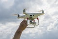 A man holding a drone on the background of cloudy sky Royalty Free Stock Photo