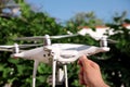 Man is holding a drone in hand and using of new technology. White quad copter Drone and photographer man hands. Royalty Free Stock Photo