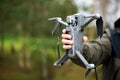 Man holding a drone with his hand before flying it through the sky Royalty Free Stock Photo