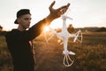 Man holding drone for propeller, sunset flare Royalty Free Stock Photo
