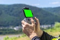 The man is holding a drone remote control with a green screen smartphone connected to it. Royalty Free Stock Photo