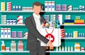 Man holding drugstore bag in front of pharmacy