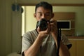 a man holding a DSLR camera and taking a picture of himself in front of the mirror Royalty Free Stock Photo