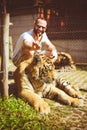 Man holding ears to the tiger Royalty Free Stock Photo