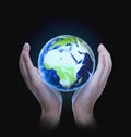 Man holding Earth on dark background Royalty Free Stock Photo