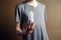 a man holding an ecological light bulb